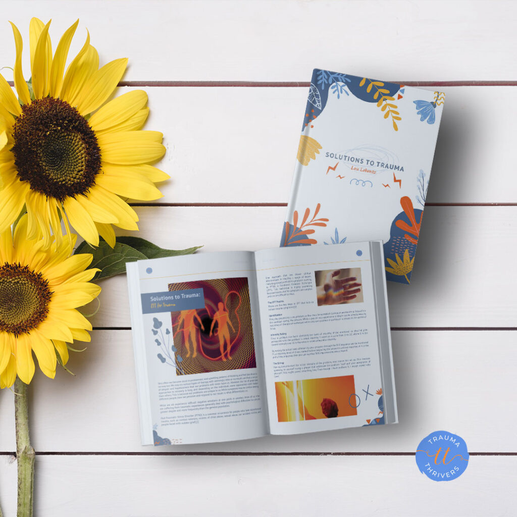 Book on trauma solutions with sunflowers on table.