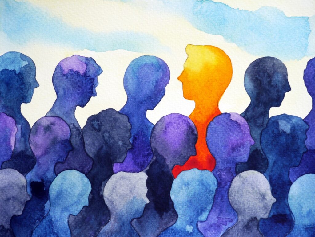 Watercolour silhouettes, one orange among blue figures.